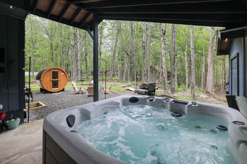 From the soothing waters of the hot tub to the unique barrel sauna nearby, embrace the perfect outdoor sanctuary designed for your rejuvenation.