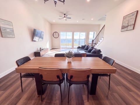 Bright open living space with waterfront views and stylish modern dining
