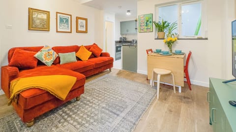 Bright and inviting open-plan lounge with comfortable seating, perfect for relaxing after a day out.