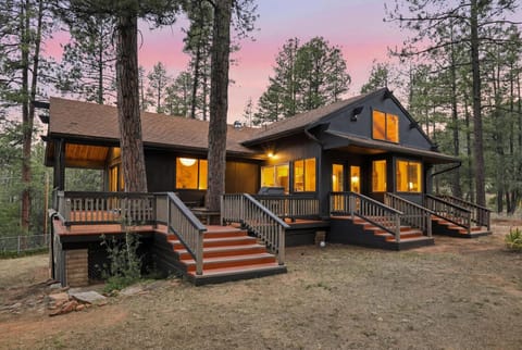 Warm woodland cabin with wraparound decks and glowing sunset views