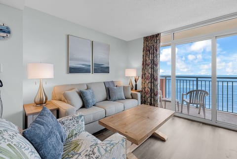 Bright beachfront living room with private balcony and stunning ocean views