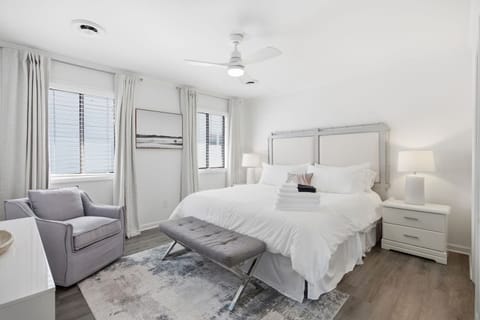 Spacious primary suite featuring a luxurious king bed with a plush mattress topper, cooling sheets, down alternative pillows, and a private ensuite bathroom
