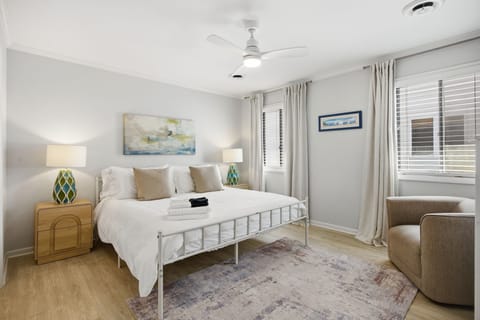 Relaxing king bedroom featuring cooling sheets, plush bedding, down alternative pillows, and soft natural light