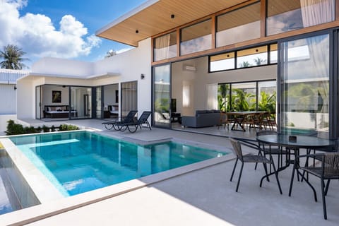 Luxury 5-star pool villa with crystalline swimming pool and modern architecture in tropical Koh Samui paradise