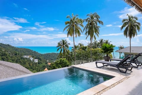 Tropical infinity pool with thatched-roof sala and ocean views at Sunrise Hill Villa, Koh Samui