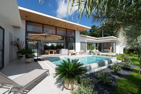 Luxurious 3-bedroom villa in Bophut Koh Samui featuring private swimming pool and lush tropical landscaping