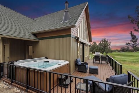 Stunning sunset views over the golf course highlight this spacious deck, perfect for soaking in the hot tub or dining al fresco after a day of exploration.