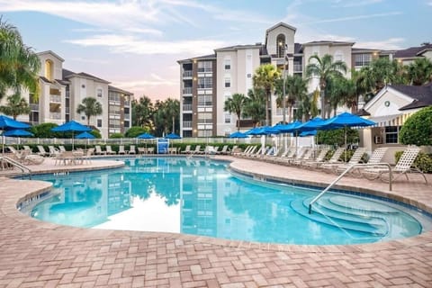 Dive into a sparkling lagoon pool at sunset calm.