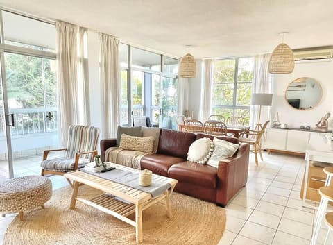  Spacious living and dining area with AC, extends to an outdoor/indoor balcony