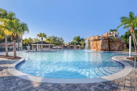 Dive into a sparkling lagoon pool beneath swaying palms.