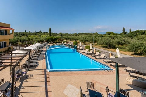 Spend sunny afternoons beside the pool, where open views across the surrounding greenery create a relaxed atmosphere from morning through to sunset.