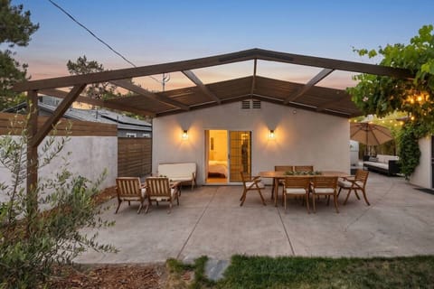 Spacious covered patio with comfortable seating and outdoor dining space for relaxing throughout the day.