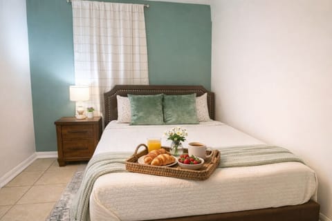Rest in comfort on a queen-size bed with plush linens and thoughtful touches, designed for a peaceful night`s sleep
