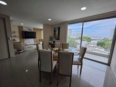 Bright open-plan living with balcony and sweeping city views