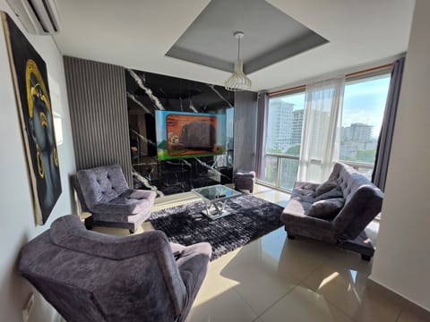 Stylish living room with city views, marble TV wall, and plush seating