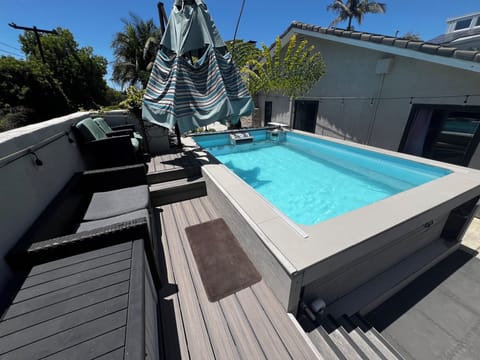Endless pool with deck and option for umbrella coverage