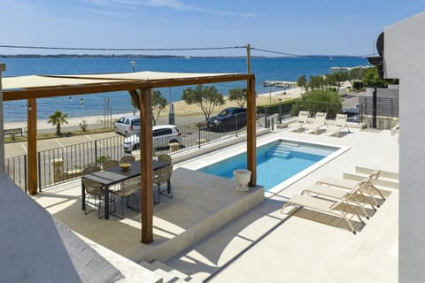Terrace of Villa Diaria with private pool, pergola and beautiful sea view.
