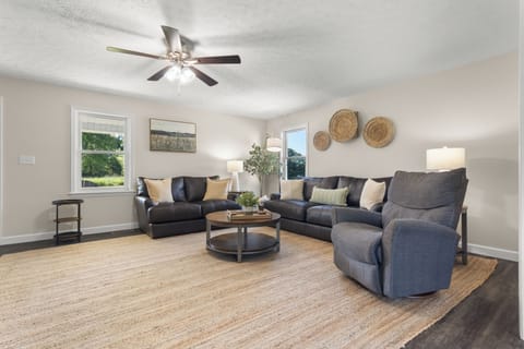 Spacious, sunlit living room with cozy seating for everyone