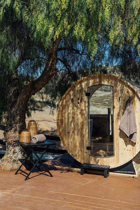 Relax beneath the shade of a sprawling pepper tree and enjoy a restorative sauna session surrounded by rolling hills and open skies.