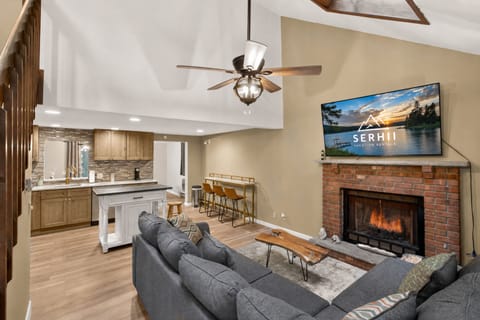 Living room with smart TV and comfortable sectional. Propane fireplace for colder months