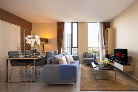 Bright modern living room with city views, dining for four, and cozy seating