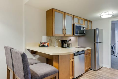 Cook quick meals in the modern kitchenette with bar seating.