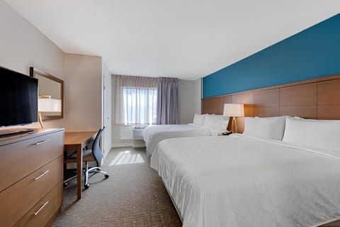 Relax into crisp bedding in a bright, airy bedroom.