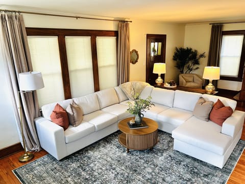 Bright, cozy living room with spacious sectional and warm classic details