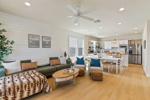 Bright open living! Co-located on the second floor with the kitchen and a powder room is a spacious open-plan layout with comfy sectional and large dining area,  — ideal for gathering with family and friends.