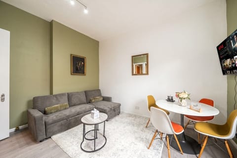 Relax on the comfy sofa with Netflix and a stylish dining nook.
