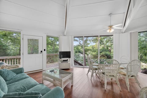 Relax in your airy sunroom with serene garden views, comfy seating, and a cozy dining nook—perfect for morning coffee or sunset cocktails.
