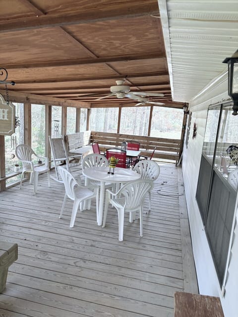 Spacious covered porch with fans, outdoor dining and woodland views