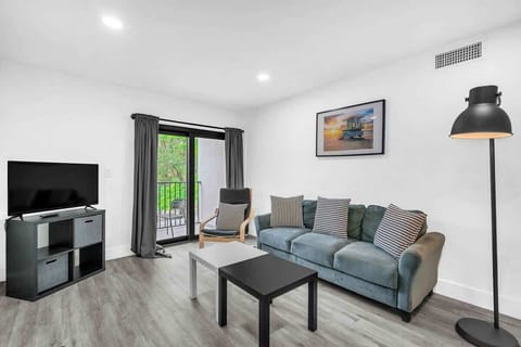 Comfortable and welcoming living area with a Smart TV, plush seating, and plenty of natural light.