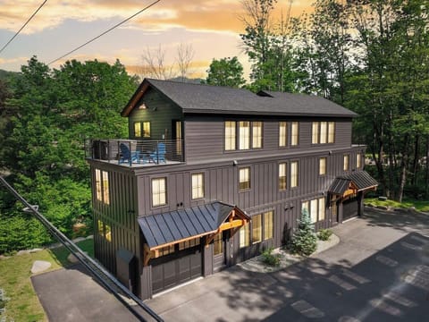 The charcoal board-and-batten exterior and timber-framed entryways give you a sense of what's inside before you even open the door.
