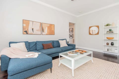 Stylish Comfort – A chic sectional, warm accents, and abstract wall art create the perfect mix of modern design and comfort.