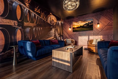 Moody speakeasy with velvet seating, wine-cellar mural, and warm designer lighting