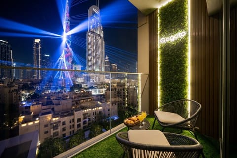 Relax on your private balcony with comfortable seating and a tea table while enjoying breathtaking night views of the Burj Khalifa and its spectacular light show—perfect for unwinding with a coffee or a peaceful evening under the Dubai skyline.