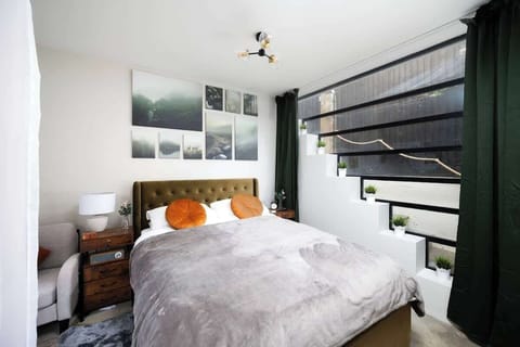 This is a one-bedroom suite, with floor-to-ceiling windows on one side and a small sitting area to the left. 