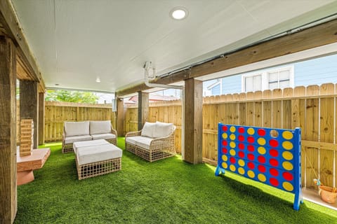 Private outdoor area under the house with cozy seating and fun lawn games.