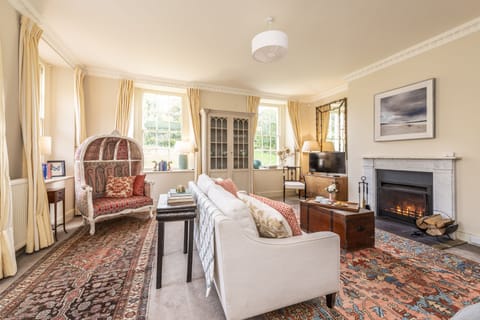 Ground floor:  The spacious sitting room with open fire and elegant furnishings