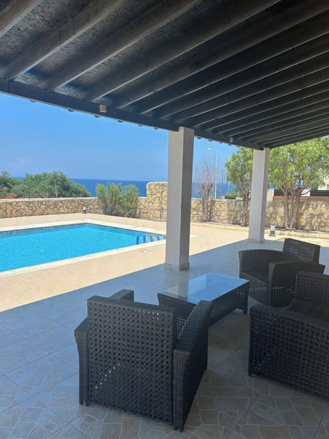Ground floor patio area overlooking pool and Mediterranean