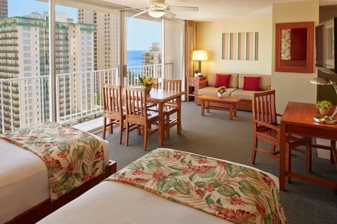 Wake to ocean views beside cozy beds and breezy balcony.