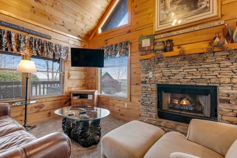 Living Room, enjoy the warmth of the stone fireplace and stunning views from the large windows!