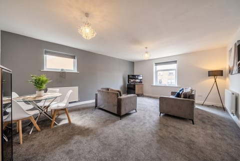 Sink into plush sofas in the bright open living and dining space made for unwinding together.