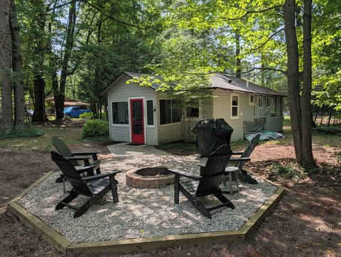 OVERVIEW: The view from the beautiful firepit and grill, aggregated with pea gravel underfoot, facing towards the cute cabin