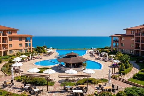 Sparkling pools and a swim-up bar overlook the endless blue sea at this resort.