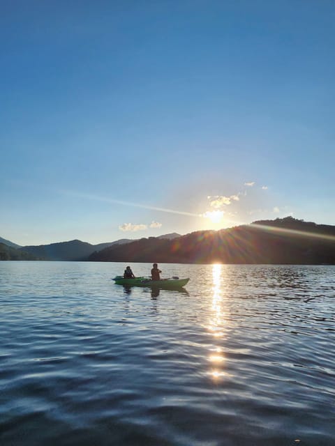 Sunset paddles on Lake Nantahala. The water is calm,the mountains are glowing 