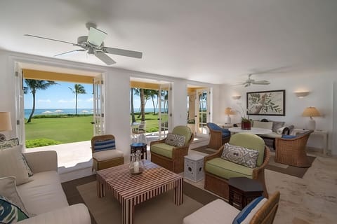 Gather in the airy lounge while doors open to the sea