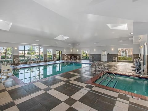 Take a refreshing dip in the inviting indoor pool, surrounded by natural light.