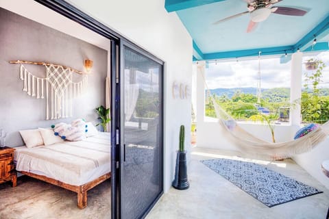 Private outdoor oasis with daybed, table and chairs, hammock, and hammock swing.